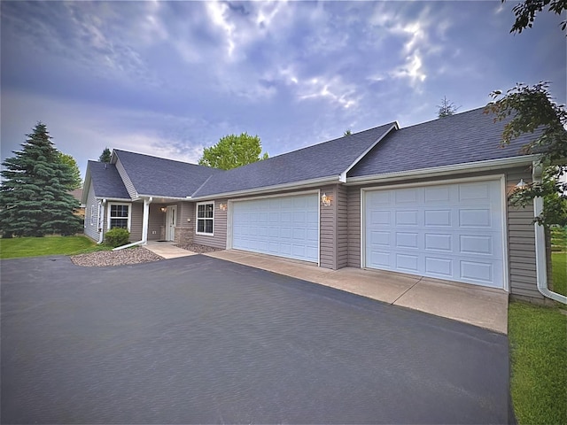 1855 Pioneer Ln Unit 1855, Centerville, MN 55038 - view of front facade featuring asphalt driveway, an attached garage, and roof with shingles