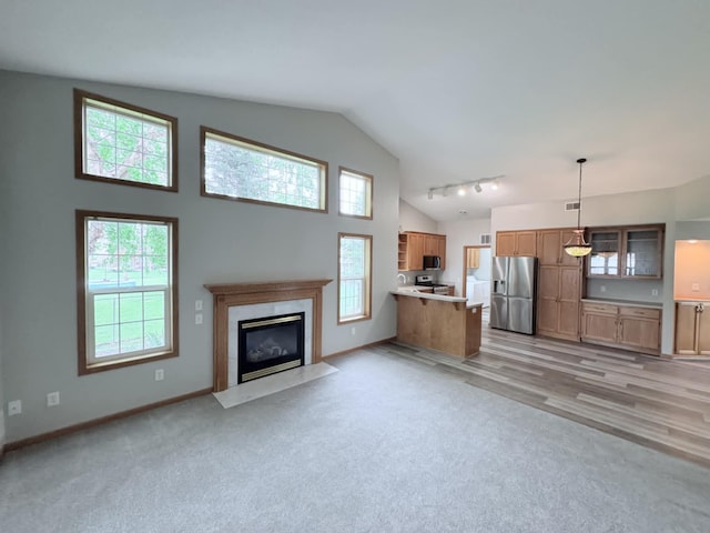 1855 Pioneer Ln Unit 1855, Centerville, MN 55038 - unfurnished living room with a premium fireplace, high vaulted ceiling, and light colored carpet