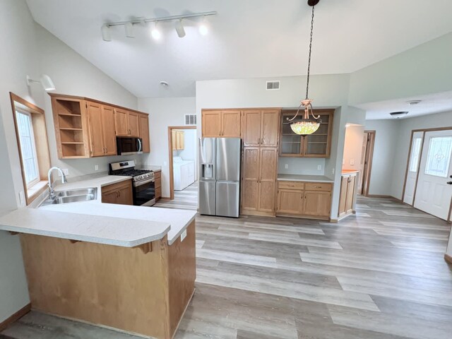 1855 Pioneer Ln Unit 1855, Centerville, MN 55038 - kitchen featuring stainless steel appliances, open shelves, washer and dryer, light countertops, and a peninsula
