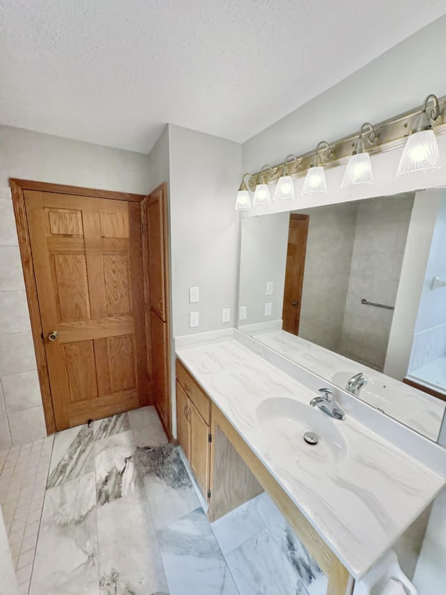 1855 Pioneer Ln Unit 1855, Centerville, MN 55038 - bathroom with a textured ceiling, vanity, and marble finish flooring