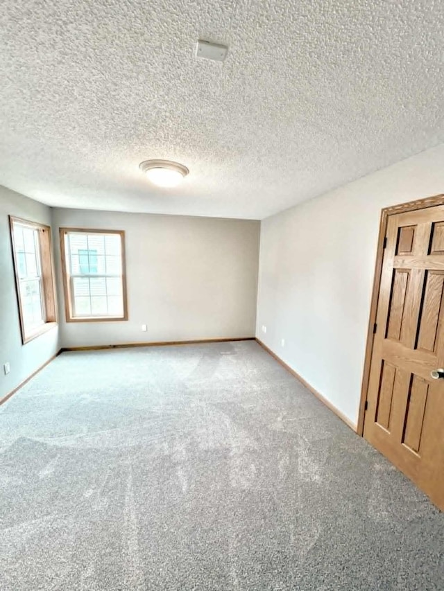 1855 Pioneer Ln Unit 1855, Centerville, MN 55038 - carpeted spare room featuring baseboards and a textured ceiling