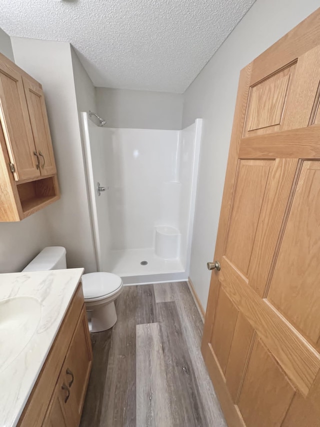 1855 Pioneer Ln Unit 1855, Centerville, MN 55038 - bathroom with wood finished floors, a walk in shower, vanity, and a textured ceiling