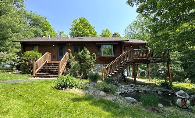 27315 Stark Lake Rd, Aitkin, MN 56431 - back of property featuring stairway, a deck, a lawn, and a shingled roof