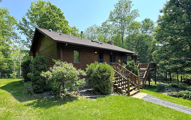 27315 Stark Lake Rd, Aitkin, MN 56431 - chalet / cabin featuring a front yard, log siding, stairway, a wooden deck, and a shingled roof