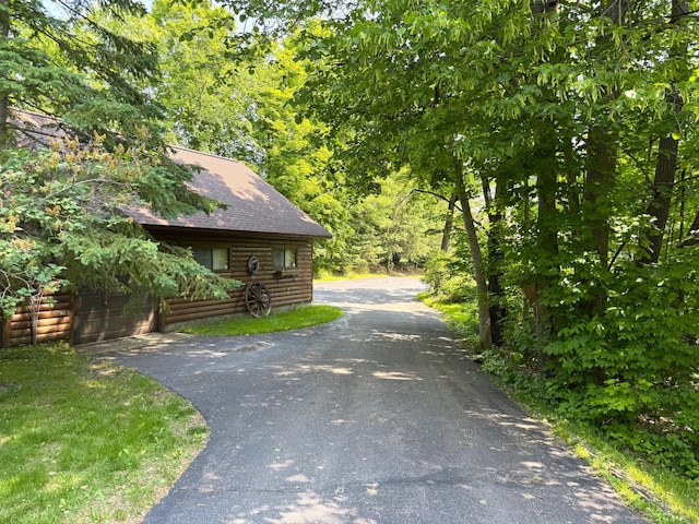27315 Stark Lake Rd, Aitkin, MN 56431 - view of property exterior with driveway, roof with shingles, and log exterior