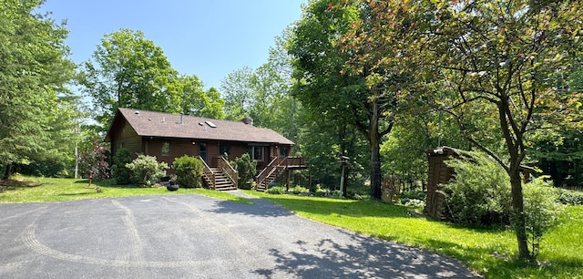 27315 Stark Lake Rd, Aitkin, MN 56431 - view of front of property with stairway, a front yard, and a deck