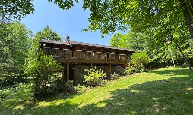 27315 Stark Lake Rd, Aitkin, MN 56431 - rear view of property featuring a chimney, a lawn, a deck, and stone siding