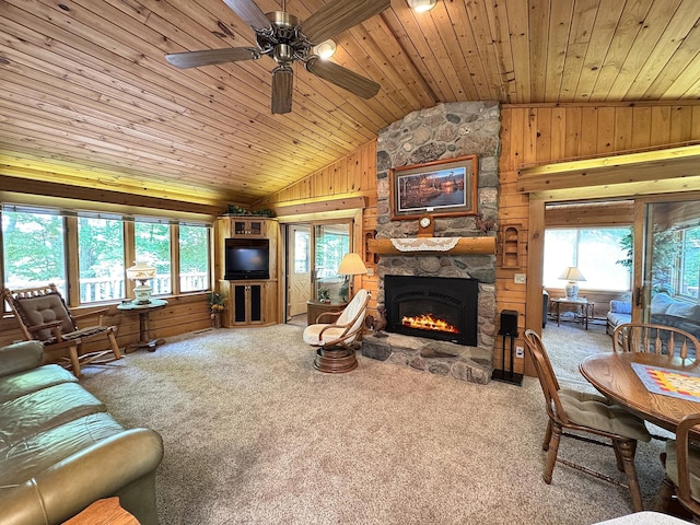 27315 Stark Lake Rd, Aitkin, MN 56431 - living room with lofted ceiling, wooden ceiling, wood walls, a stone fireplace, and plenty of natural light