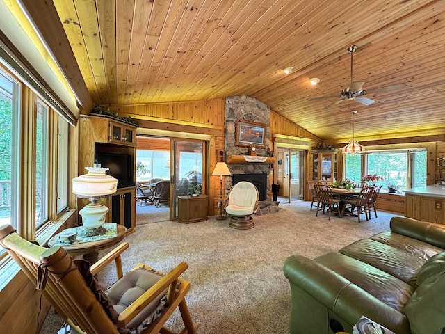 27315 Stark Lake Rd, Aitkin, MN 56431 - living room with lofted ceiling, wood walls, wood ceiling, carpet floors, and a stone fireplace
