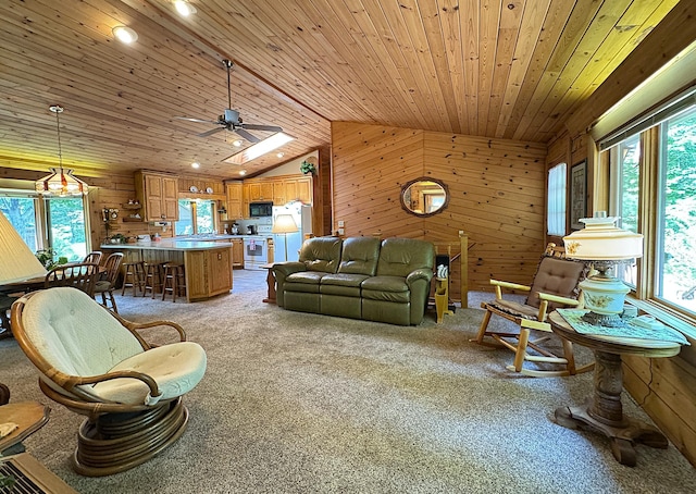 27315 Stark Lake Rd, Aitkin, MN 56431 - living area with healthy amount of natural light, wooden walls, light carpet, lofted ceiling, and ceiling fan