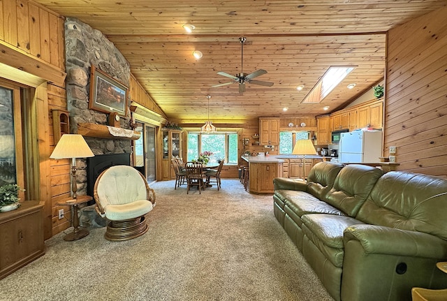 27315 Stark Lake Rd, Aitkin, MN 56431 - living room featuring vaulted ceiling, light carpet, wood walls, ceiling fan, and wooden ceiling
