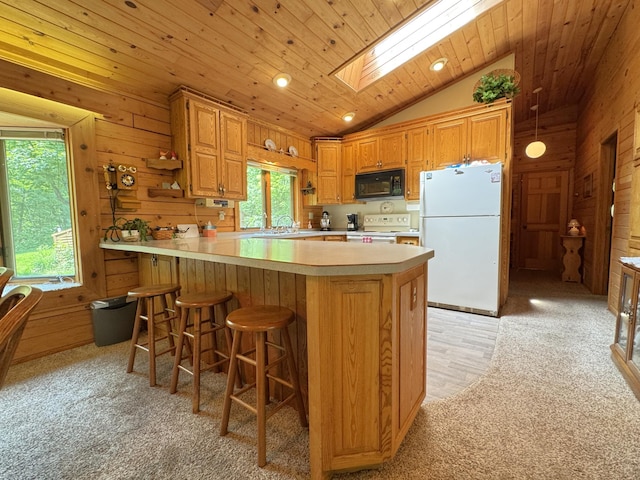 27315 Stark Lake Rd, Aitkin, MN 56431 - kitchen featuring light carpet, white appliances, light countertops, lofted ceiling, and wooden walls
