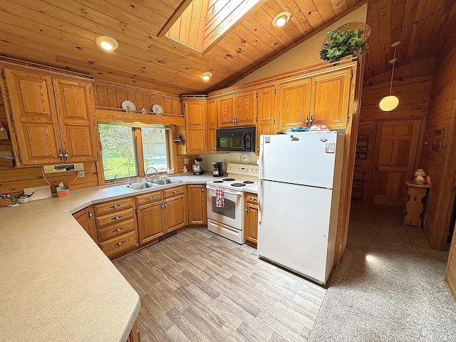 27315 Stark Lake Rd, Aitkin, MN 56431 - kitchen with white appliances, light countertops, vaulted ceiling, a skylight, and brown cabinetry