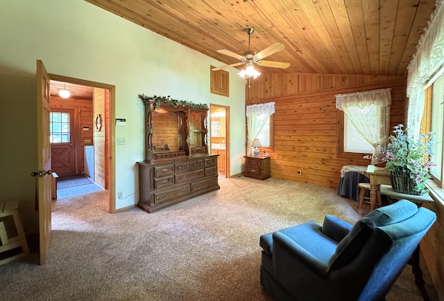 27315 Stark Lake Rd, Aitkin, MN 56431 - living area featuring lofted ceiling, wood ceiling, carpet, a ceiling fan, and wood walls