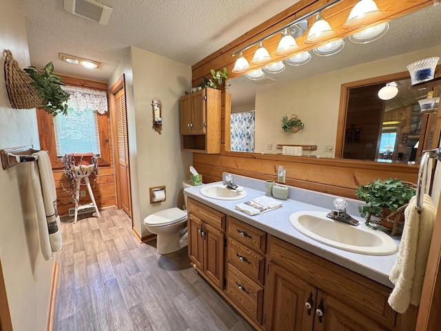 27315 Stark Lake Rd, Aitkin, MN 56431 - bathroom featuring double vanity, wood finished floors, and wooden walls