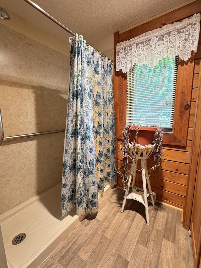 27315 Stark Lake Rd, Aitkin, MN 56431 - full bath with wood finished floors, curtained shower, and a textured ceiling
