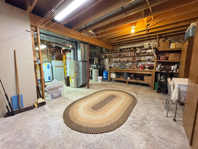 27315 Stark Lake Rd, Aitkin, MN 56431 - unfinished below grade area featuring a workshop area, water heater, heating unit, and a water pressure tank