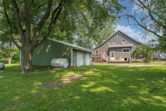 43867 County Road 15, New Sweden Twp, MN 56074 - rear view of property with an outdoor structure, a garage, a deck, a yard, and heating fuel