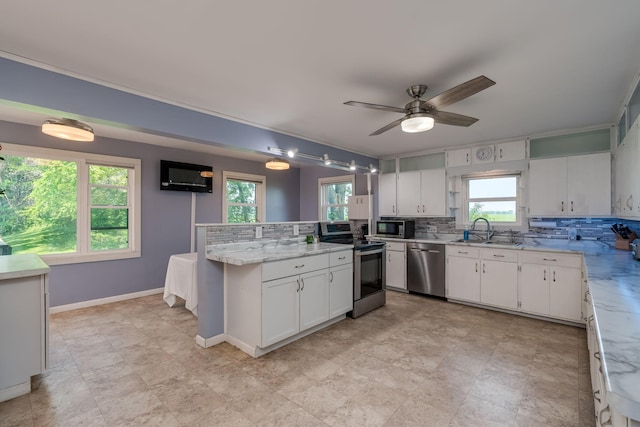43867 County Road 15, New Sweden Twp, MN 56074 - kitchen with stainless steel appliances, backsplash, white cabinets, and plenty of natural light