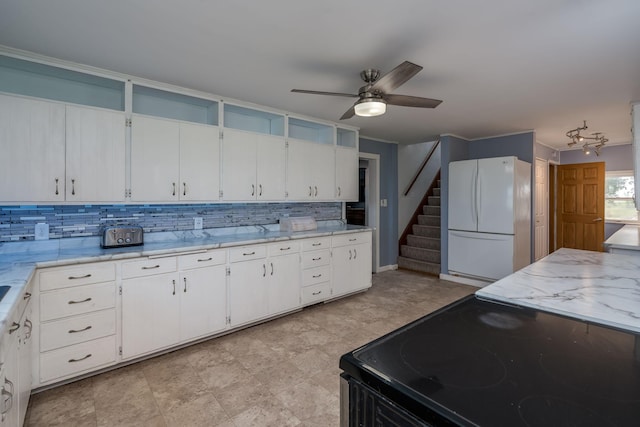 43867 County Road 15, New Sweden Twp, MN 56074 - kitchen featuring freestanding refrigerator, electric range, decorative backsplash, a ceiling fan, and white cabinets