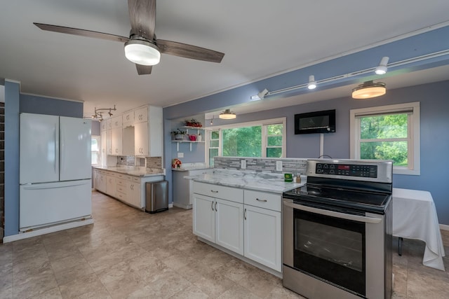 43867 County Road 15, New Sweden Twp, MN 56074 - kitchen featuring stainless steel range with electric cooktop, freestanding refrigerator, tasteful backsplash, and white cabinets