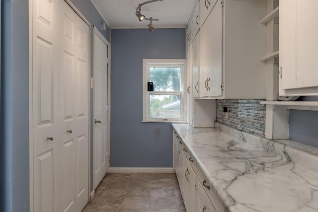 43867 County Road 15, New Sweden Twp, MN 56074 - kitchen with backsplash, ornamental molding, white cabinetry, and track lighting