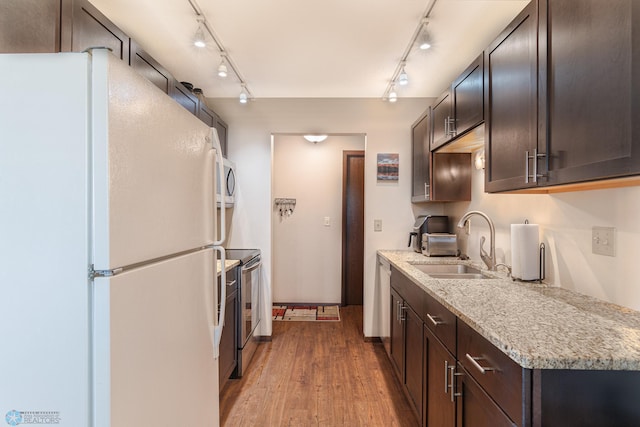 1129 22nd St S Unit B12, Fargo, ND 58103 - kitchen featuring appliances with stainless steel finishes, track lighting, dark brown cabinets, and wood finished floors