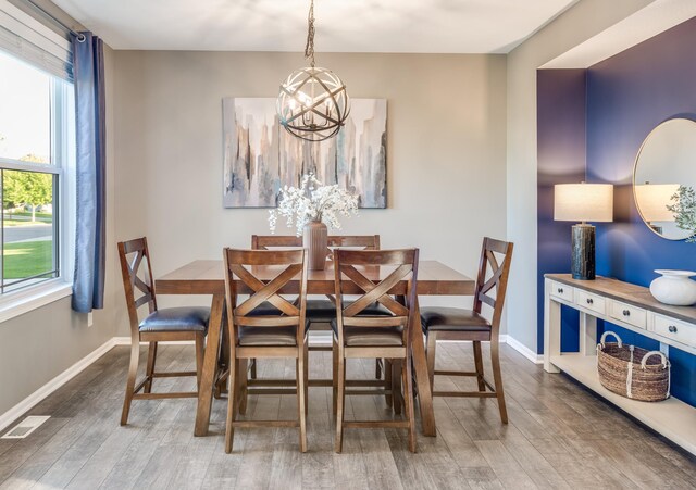 10329 Kentucky Ave N, Brooklyn Park, MN 55445 - dining space with a chandelier and wood finished floors