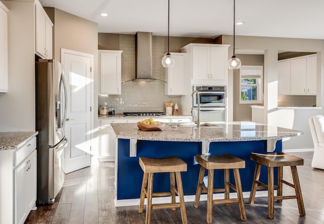 10329 Kentucky Ave N, Brooklyn Park, MN 55445 - kitchen with appliances with stainless steel finishes, wall chimney exhaust hood, backsplash, dark wood-style flooring, and recessed lighting