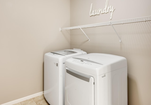 10329 Kentucky Ave N, Brooklyn Park, MN 55445 - laundry area featuring washer and clothes dryer and baseboards