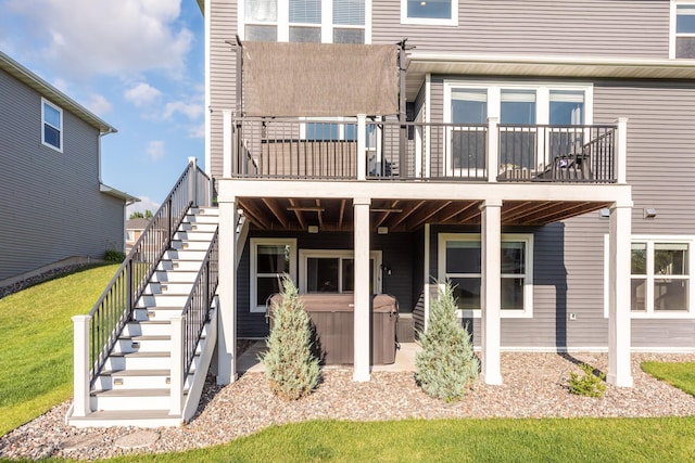 10329 Kentucky Ave N, Brooklyn Park, MN 55445 - rear view of house with a hot tub, stairway, and a deck