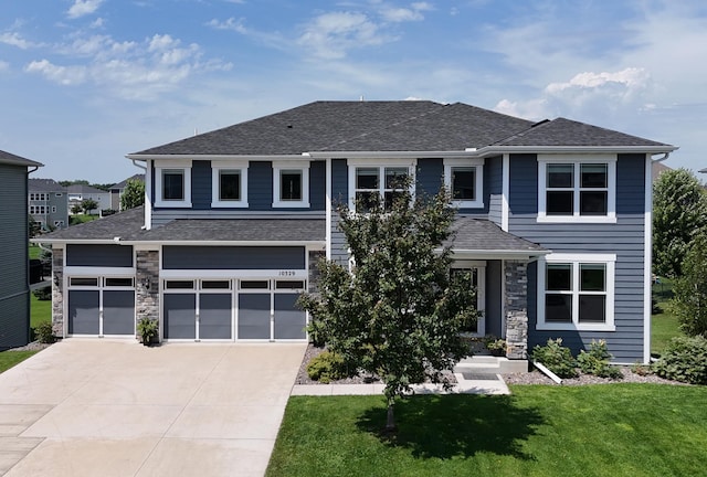 10329 Kentucky Ave N, Brooklyn Park, MN 55445 - prairie-style house with stone siding, concrete driveway, a front lawn, and a garage
