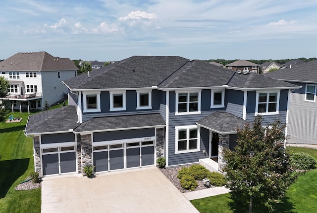 10329 Kentucky Ave N, Brooklyn Park, MN 55445 - view of front of property featuring driveway, a residential view, a garage, stone siding, and a shingled roof