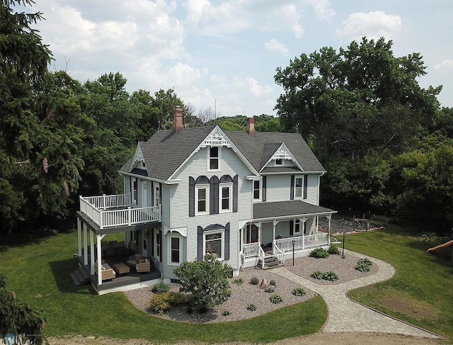 5560 County Road 3, Kindred, ND 58051 - victorian-style house with a chimney, an outdoor living space, covered porch, a front yard, and roof with shingles