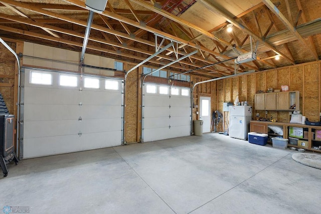 5560 County Road 3, Kindred, ND 58051 - garage with freestanding refrigerator and a garage door opener