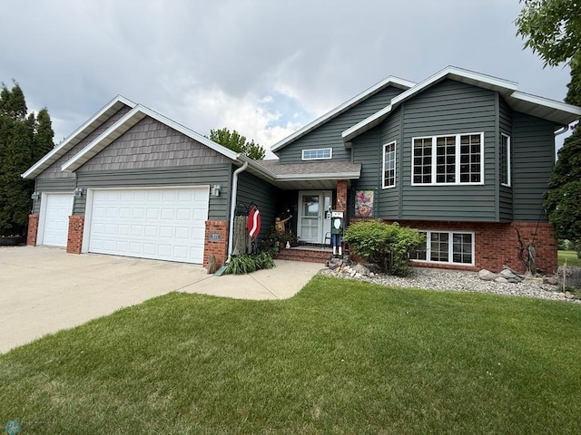 521 Kroshus Dr, Dilworth, MN 56529 - split level home featuring a garage, driveway, a front lawn, and brick siding