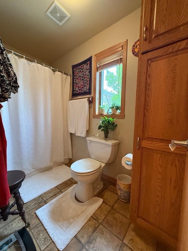 521 Kroshus Dr, Dilworth, MN 56529 - bathroom with toilet, curtained shower, and baseboards