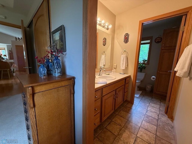 521 Kroshus Dr, Dilworth, MN 56529 - bathroom featuring vanity, toilet, and stone tile flooring