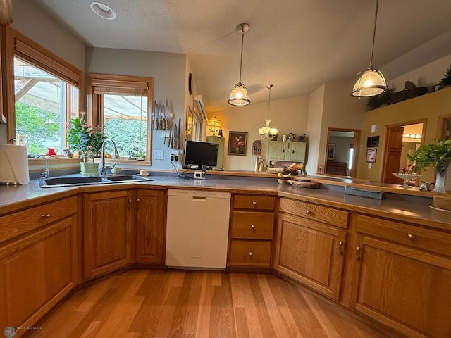 521 Kroshus Dr, Dilworth, MN 56529 - kitchen featuring dishwasher, a sink, brown cabinetry, light wood-style floors, and lofted ceiling