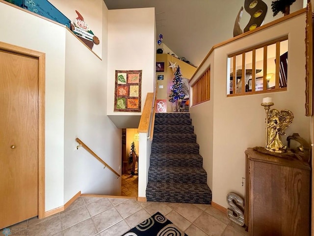 521 Kroshus Dr, Dilworth, MN 56529 - staircase with lofted ceiling, tile patterned floors, and baseboards