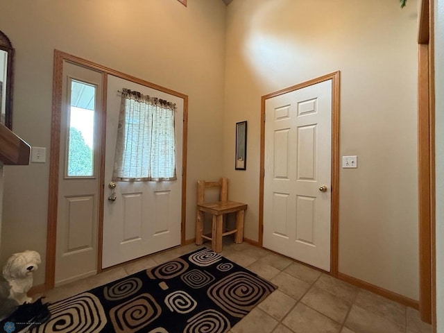 521 Kroshus Dr, Dilworth, MN 56529 - foyer with a towering ceiling, light tile patterned floors, and baseboards