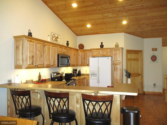 37760 Dove St Unit 14, Aitkin, MN 56431 - kitchen with stainless steel appliances, wood ceiling, a peninsula, a breakfast bar area, and light countertops