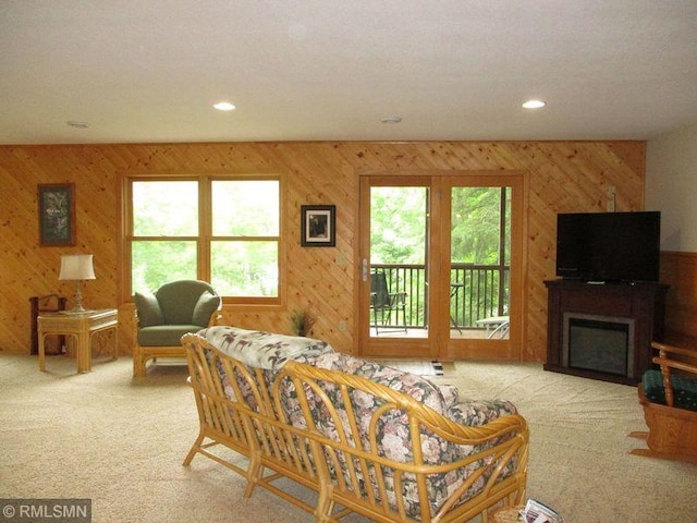 37760 Dove St Unit 14, Aitkin, MN 56431 - carpeted living area with wood walls, a fireplace, and recessed lighting