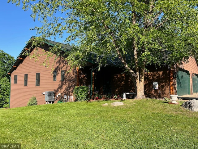 37760 Dove St Unit 14, Aitkin, MN 56431 - view of green lawn featuring a garage