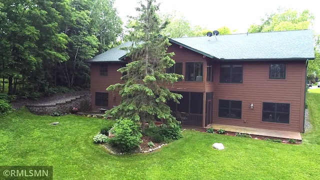 37760 Dove St Unit 14, Aitkin, MN 56431 - rear view of house with a lawn and a sunroom