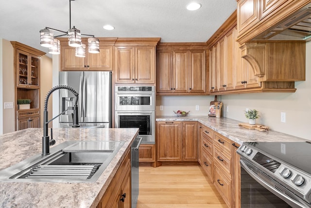 3546 230th St E, Prior Lake, MN 55372 - kitchen with stainless steel appliances, light wood-style floors, decorative light fixtures, recessed lighting, and premium range hood