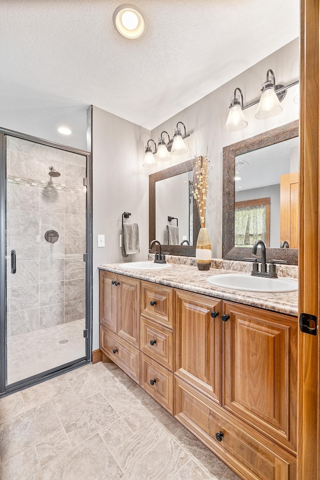 3546 230th St E, Prior Lake, MN 55372 - full bath with double vanity, a shower stall, a textured ceiling, and recessed lighting