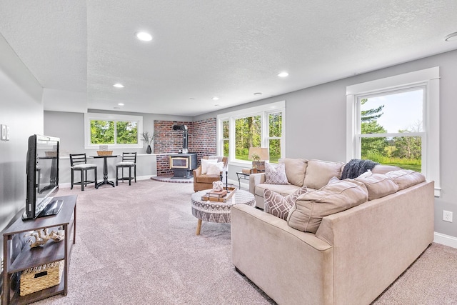 3546 230th St E, Prior Lake, MN 55372 - living room featuring a wood stove, carpet, a textured ceiling, plenty of natural light, and recessed lighting