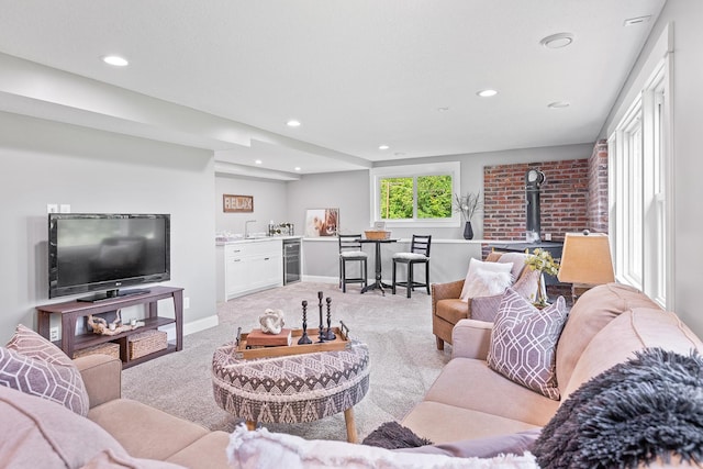 3546 230th St E, Prior Lake, MN 55372 - living area featuring beverage cooler, a wood stove, light colored carpet, recessed lighting, and bar