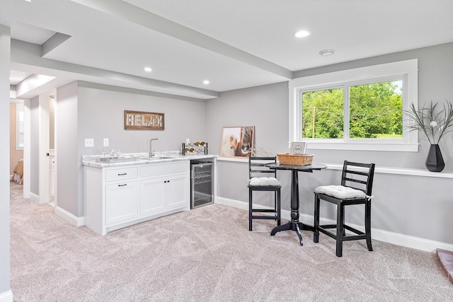 3546 230th St E, Prior Lake, MN 55372 - kitchen with beverage cooler, light colored carpet, white cabinets, recessed lighting, and light countertops